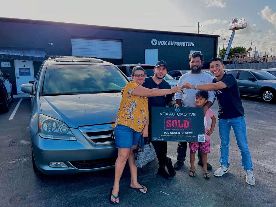 Vox Automotive family receiving their car keys outside the dealership